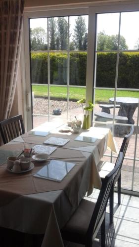 a table in a room with a large window at Tir Na Nog B&B in Cashel