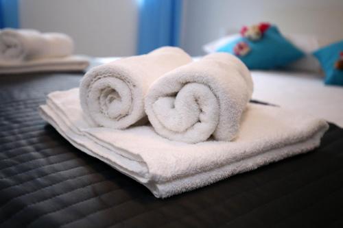 a pile of towels sitting on top of a bed at NeRea Apartment Molat in Molat
