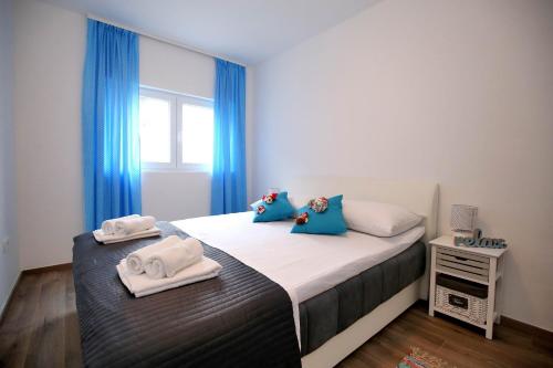 a bedroom with a bed with towels on it at NeRea Apartment Molat in Molat