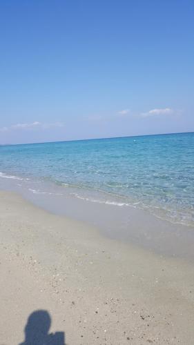 a shadow of a person taking a picture of the ocean at SUN RESIDENCE Exclusive Seaside Suites in Polykhrono