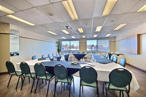 a conference room with a long table and chairs at Chateau Roberval in Roberval