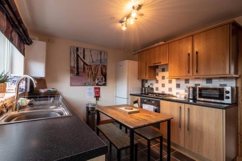 a kitchen with a sink and a counter top at Allanvale Holiday Home in Inverness