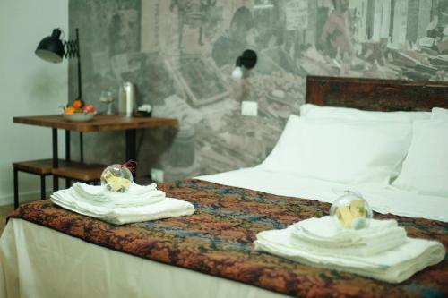 a bedroom with a bed with towels on it at Ai Tre Mercati in Palermo