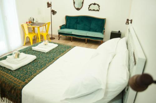 a bedroom with a bed and a blue couch at Ai Tre Mercati in Palermo
