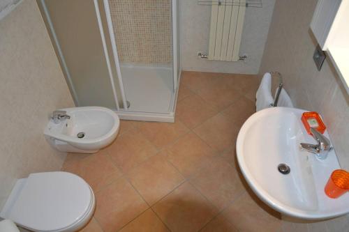 ein Bad mit einem Waschbecken, einem WC und einer Dusche in der Unterkunft Studio Casta in Bellagio