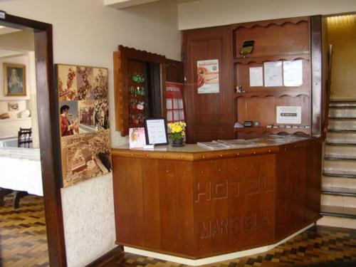 a restaurant with a counter in a room at Hotel Maristela in São Joaquim