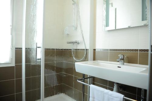 a bathroom with a shower and a sink at Hotel Restaurant Txistulari in Itxassou