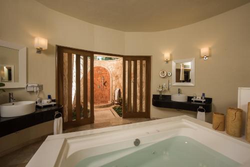 a large bathroom with a tub and two sinks at Grand Riviera Princess - All Inclusive in Playa del Carmen