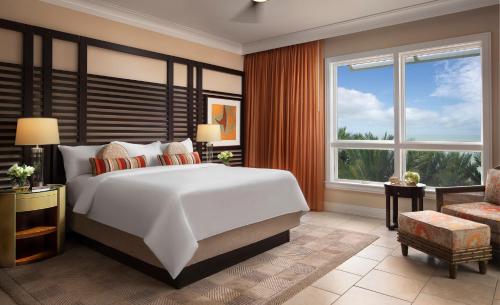 a bedroom with a large white bed and a window at The Residences on Siesta Key Beach by Hyatt Vacation Club in Sarasota