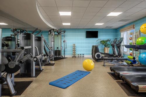 a fitness room with a gym with equipment and a yellow balloon at The Residences on Siesta Key Beach by Hyatt Vacation Club in Sarasota
