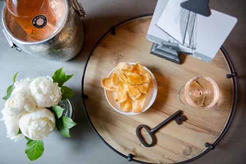 a glass table with a bowl of chips and a drink at The Restoration Hotel in Charleston