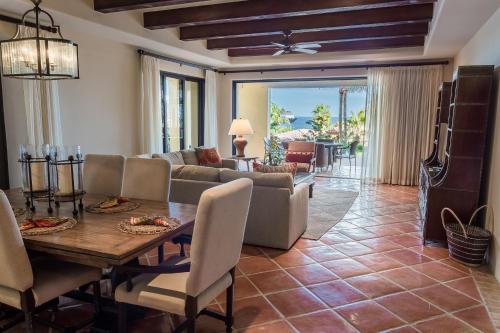 a living room with a table and a couch at Hacienda Beach Club & Residences in Cabo San Lucas