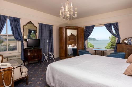 a bedroom with a bed and a large window at Union Hotel in Benicia