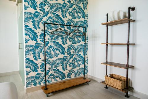 a room with a blue and white wallpaper at Numero Uno Beach House in San Juan