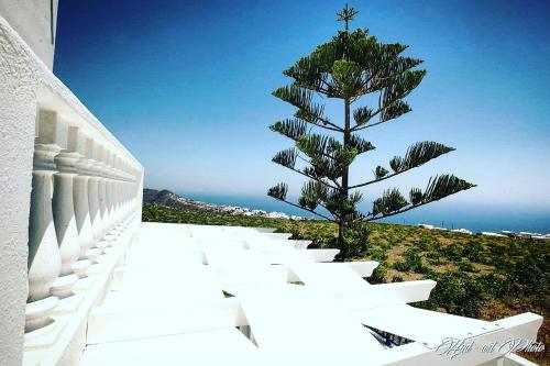 a christmas tree on the side of a building at Villa Happening in Imerovigli