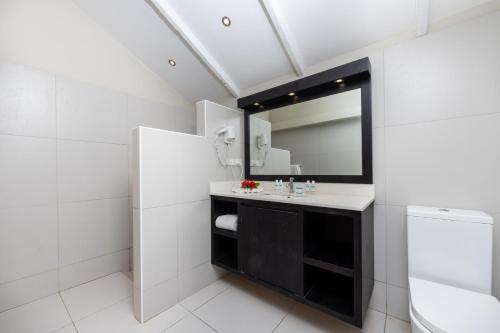 a bathroom with a sink and a mirror at Plantation Island Resort in Malolo Lailai