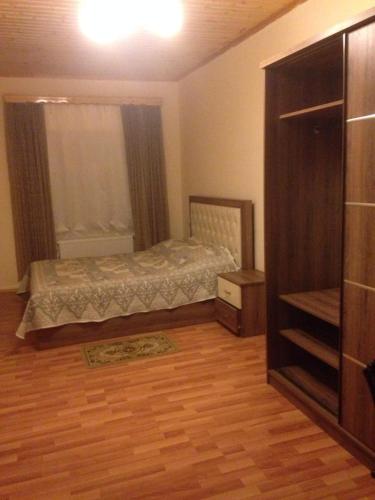 a bedroom with a bed and a dresser in it at Hotel Bulaq in Turist