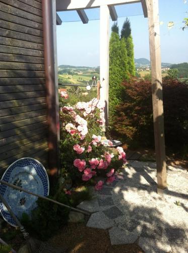 a view from a porch with pink flowers at Gästeapartement Schlossblick in Kapfenstein