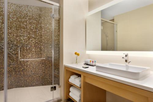a bathroom with a sink and a shower at Hyatt Place Beijing Daxing in Daxing