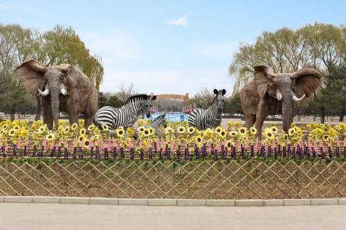 three statues of elephants and zebras in a park at Hyatt Place Beijing Daxing in Daxing