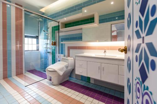 a bathroom with a toilet and a sink and a shower at Hogwarts Castle Guest House in Wujie