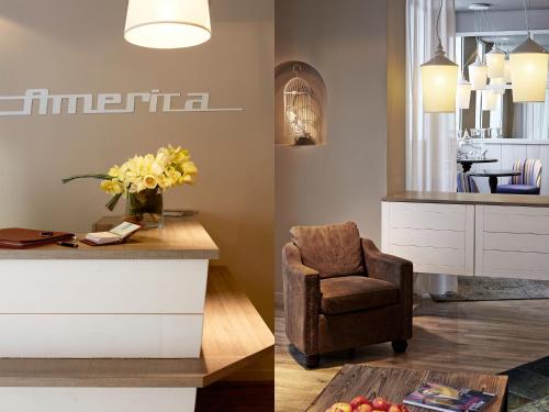a living room with a chair and a table at Hotel America in Cannes