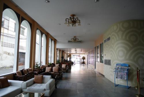 a lobby with couches and chairs in a building at Roma Hotel in Khon Kaen