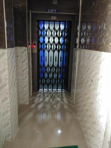 a door in a room with a tile floor and a window at MSR Lodge in Tirupati