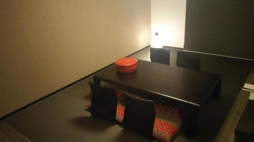 a black table with pillows and an orange container on it at Takamatsu Tokyu REI Hotel in Takamatsu