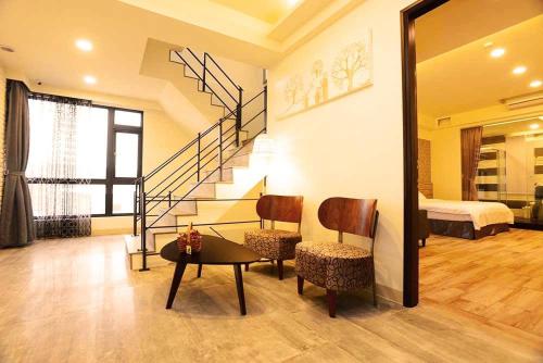 a living room with a staircase and a bedroom at Summer Lotus in Huxi