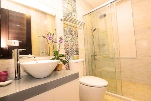 a bathroom with a toilet and a sink and a shower at Summer Lotus in Huxi