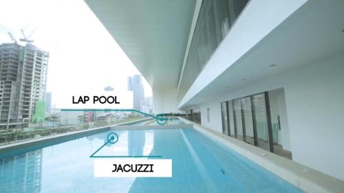 a swimming pool in the middle of a building at Sakura House in Manila