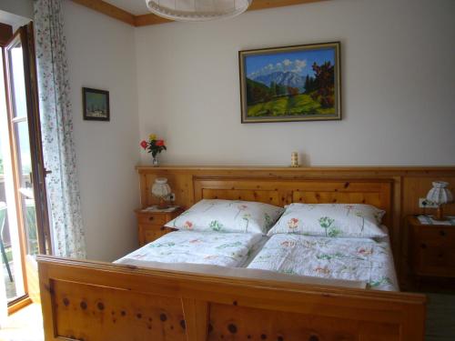 a bedroom with a bed and a picture on the wall at Eichenhof in Berg im Drautal