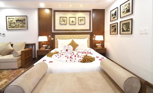 a bedroom with a bed with flowers on it at Garco Dragon Hotel 2 in Hanoi