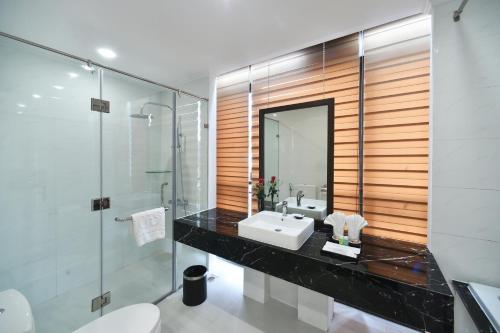 a bathroom with a sink and a shower at Garco Dragon Hotel 2 in Hanoi