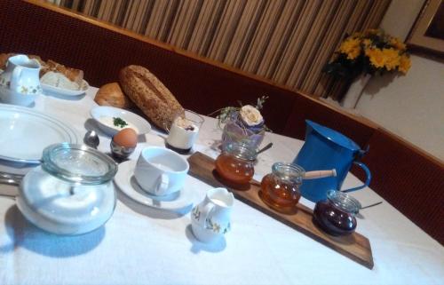 a table with a table cloth with food on it at Zimmer - Hinterwalderhof in Mühlbach