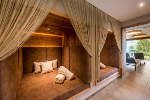 a room with a bed in a house with curtains at Apart & Suiten Hotel WEIDEN in Schladming