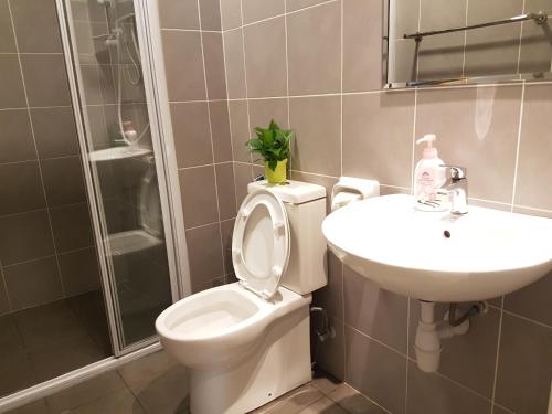a bathroom with a toilet and a sink at Southville Stay 2 @ Savanna Executive Suite in Kampong Tangkas