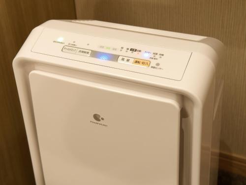 a white refrigerator freezer sitting next to a wall at Hotel Keihan Tsukiji Ginza Grande in Tokyo