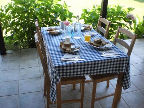 a blue and white table with food and drinks on it at Vergina Pension in Sarti