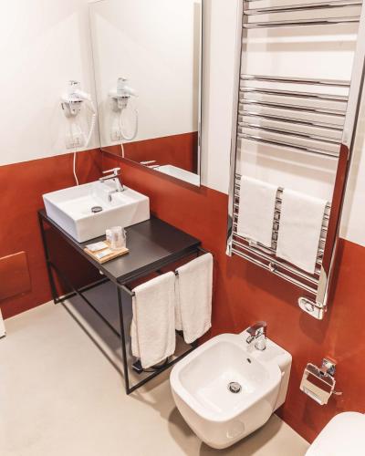 a bathroom with a white sink and a mirror at Relais Della Porta in Naples
