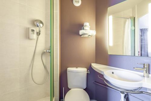 a bathroom with a shower and a toilet and a sink at B&B HOTEL Toulon Ollioules in Ollioules