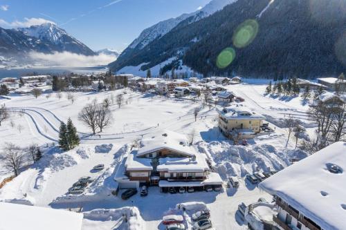a resort in the mountains with snow on the ground at Appartements Fortuna in Pertisau