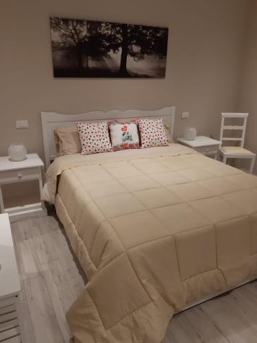 a bedroom with a large bed with two pillows at Reggiolacittàinvisibile B&B in Reggio Emilia