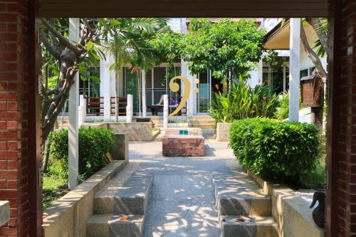 a courtyard with a sculpture in front of a building at My Way Hua Hin Music Hotel SHA Extra Plus in Hua Hin