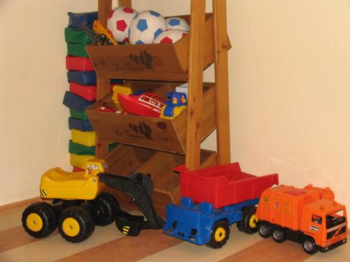 a group of toys sitting on the floor next to a shelf at Hotel Augarten in Neustift im Stubaital