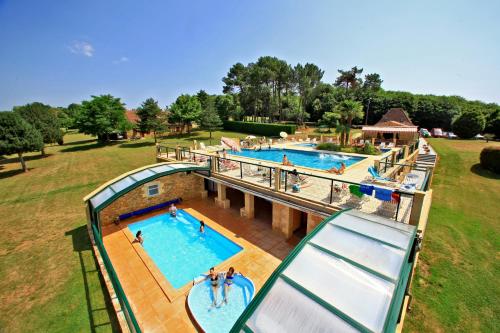 an overhead view of a pool at a resort at COMBAS village de gites in Saint-Crépin-et-Carlucet
