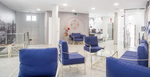 a waiting room with blue chairs in a salon at Itaca Artemisa by Soho Boutique in Seville