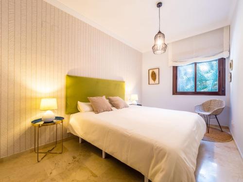 A bed or beds in a room at MALAGA CENTER EXPERIENCE - Premium Apartment