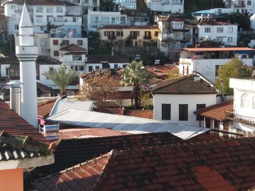 a view of a city with roofs and a church at Sakura Hostel Fethiye in Fethiye